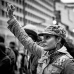 Black and white photo of a Woman holding up her fist