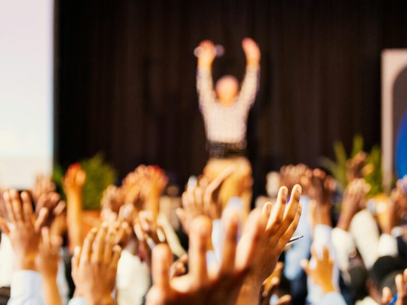 Image of many raised hands