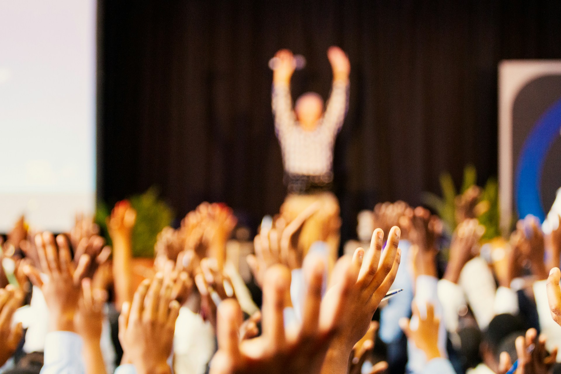 Image of many raised hands